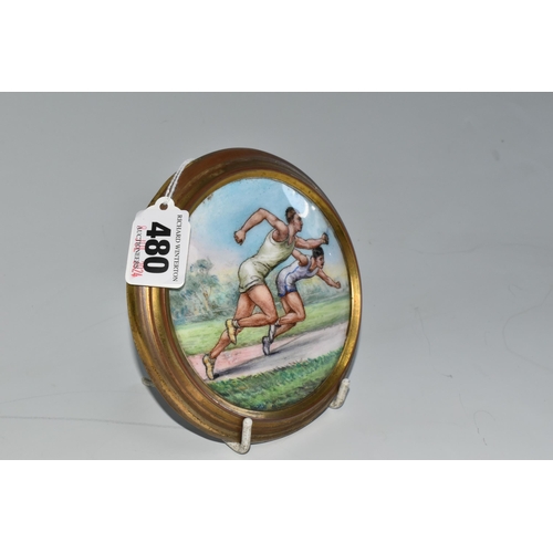 480 - AN EARLY 20TH CENTURY SPORTING ENAMEL PLAQUE DEPICTING TWO MALE ATHLETES IN A SPRINT, brass coated c... 