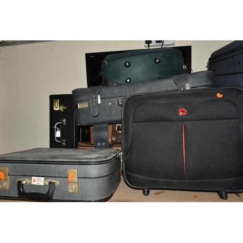 513 - ELEVEN MIXED SUITCASES to include a 43cm x 34cm x 23cm Swiss soft carry on case, a 67cm x 57cm x 24c... 