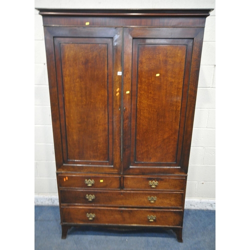 1175 - A GEORGIAN MAHOGANY LINENPRESS, the double doors enclosing four linen slides, atop a base fitted wit... 