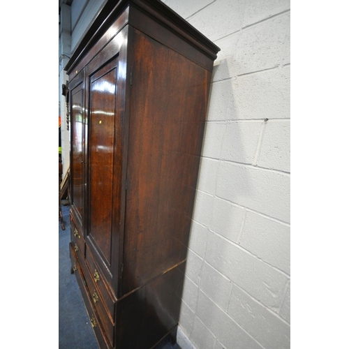 1175 - A GEORGIAN MAHOGANY LINENPRESS, the double doors enclosing four linen slides, atop a base fitted wit... 