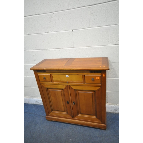 1180 - A MODERN CHERRYWOOD CABINET, with a hidden revolving pen tidy, three drawers and double cupboard doo... 