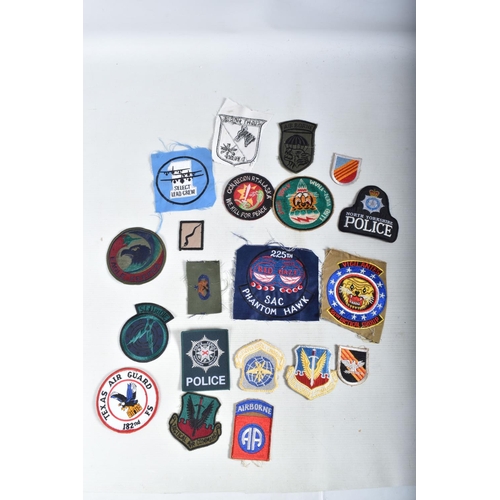 411 - AN ASSORTMENT OF MILITARIA FROM DIFFERENT COUNTRIES, to include maps from Cambodia and Vietnam, a ph... 