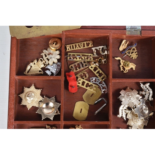 446 - A TRAY OF MILITARY CAP BADGES, five steel helmets and four military bags/ pouches, the display case ... 