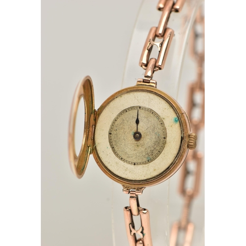 95 - A LADIES 9CT GOLD AND PINK GUILLOCHE ENAMEL WRISTWATCH, manual wind, half hunter style, round dial w... 