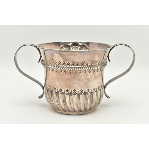 133 - A GEORGE II SILVER DOUBLE HANDLED PORRINGER, stop reeded design with embossed cherub engraved circul... 