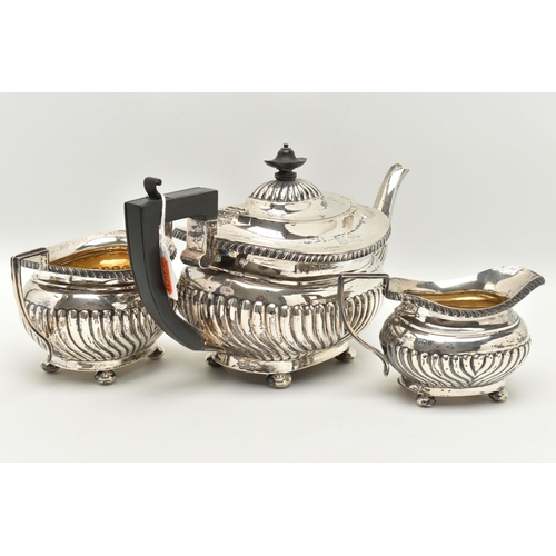 134 - A GEORGE V THREE PIECE SILVER TEA SET, comprising of a tea pot fitted with an ebonised handle and fi... 