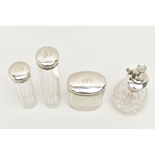 140 - THREE EARLY 20TH CENTURY GLASS TOILET JARS AND A PERFUME ATOMISER, to include an oval glass jar with... 