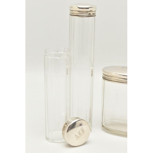 140 - THREE EARLY 20TH CENTURY GLASS TOILET JARS AND A PERFUME ATOMISER, to include an oval glass jar with... 