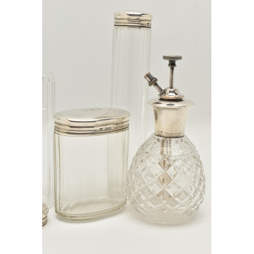 140 - THREE EARLY 20TH CENTURY GLASS TOILET JARS AND A PERFUME ATOMISER, to include an oval glass jar with... 