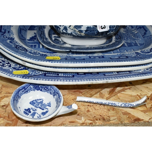 333 - A COLLECTION OF BLUE AND WHITE 'WILLOW' PATTERN TABLEWARE, comprising a large early 20th century mea... 