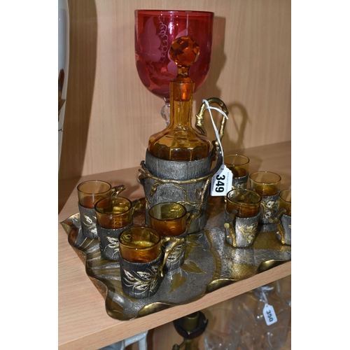 349 - A GROUP OF DECORATIVE GLASSWARE, comprising a nine piece amber glass liqueur set, with handles in th... 