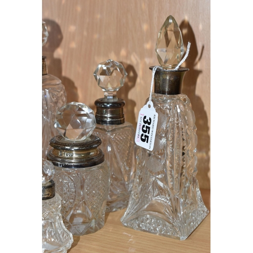 355 - EIGHT GLASS SCENT BOTTLES, with silver collars or covers, comprising a square based scent bottle, co... 