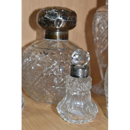 355 - EIGHT GLASS SCENT BOTTLES, with silver collars or covers, comprising a square based scent bottle, co... 