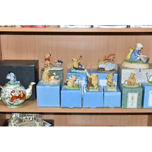 375 - A COLLECTION OF BOXED WINNIE THE POOH COLLECTABLES, comprising a Pooh and Christopher Robin ceramic ... 