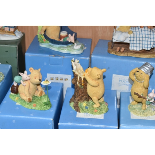 375 - A COLLECTION OF BOXED WINNIE THE POOH COLLECTABLES, comprising a Pooh and Christopher Robin ceramic ... 