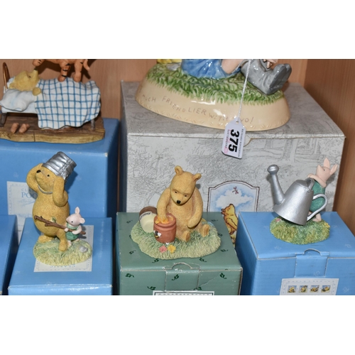 375 - A COLLECTION OF BOXED WINNIE THE POOH COLLECTABLES, comprising a Pooh and Christopher Robin ceramic ... 