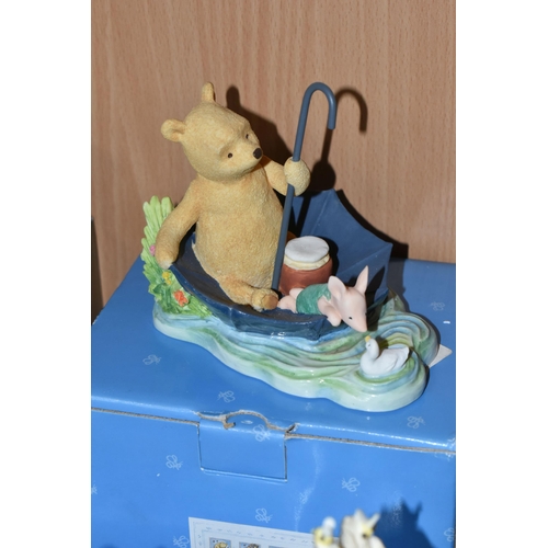 375 - A COLLECTION OF BOXED WINNIE THE POOH COLLECTABLES, comprising a Pooh and Christopher Robin ceramic ... 