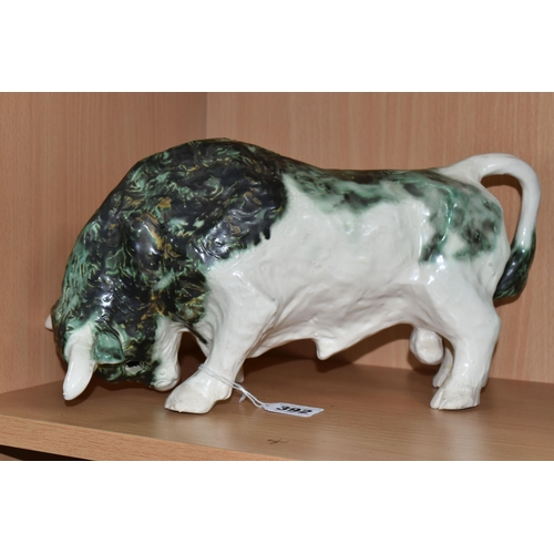 392 - A PAULA HUMPHRIES OF POLPERRO STUDIO POTTERY BULL, decorated with a black, green and white glaze, im... 