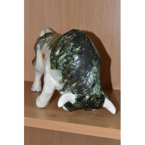 392 - A PAULA HUMPHRIES OF POLPERRO STUDIO POTTERY BULL, decorated with a black, green and white glaze, im... 