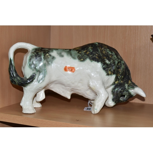 392 - A PAULA HUMPHRIES OF POLPERRO STUDIO POTTERY BULL, decorated with a black, green and white glaze, im... 