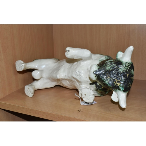 392 - A PAULA HUMPHRIES OF POLPERRO STUDIO POTTERY BULL, decorated with a black, green and white glaze, im... 