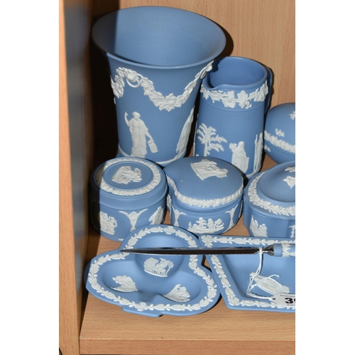 394 - A GROUP OF WEDGWOOD BLUE JASPERWARE, comprising a paper knife, six trinket dishes, a Christmas 1973 ... 