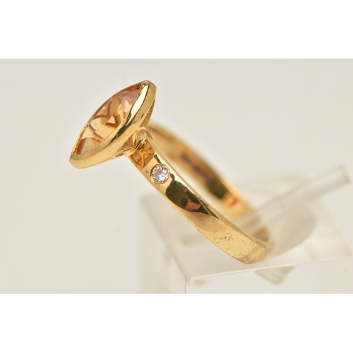 13 - A 9CT GOLD GEM SET RING, an marquise cut orange stone assessed as citrine, bezel set in yellow gold,... 
