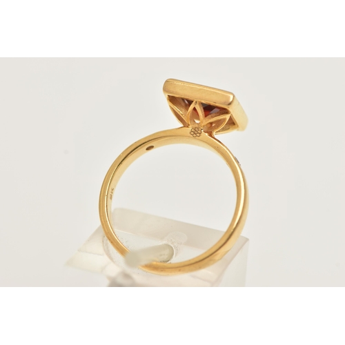 31 - A 9CT GOLD GEM SET RING, a square cut red stone assessed as garnet, bezel set in yellow gold, flanke... 