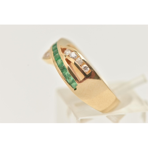 37 - A MODERN YELLOW METAL DIAMOND AND EMERALD DRESS RING, the ring is of cross over design, set with a r... 