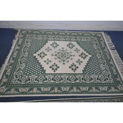 1213 - A RECTANGULAR CREAM AND GREEN WOOLEN RUG, 244cm x 172cm, along with a matching runner (condition rep... 