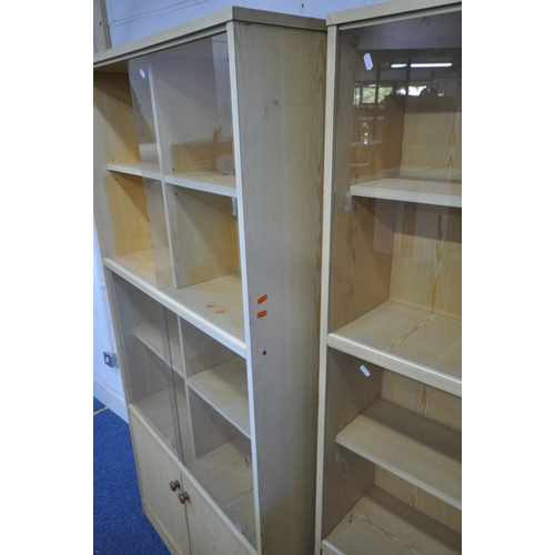 1218 - A PAIR OF MODERN BOOKCASES, with glass sliding doors, above double cupboard doors, width 91cm x dept... 