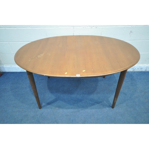 1223 - A MID CENTURY TEAK OVAL EXTENDING DINING TABLE, with two additional leaves, raised on cylindrical ta... 