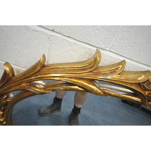 1236 - A LARGE FLAMBOYANT REPRODUCTION GILT RESIN WALL MIRROR, 183cm x 120cm (condition report: small chips... 