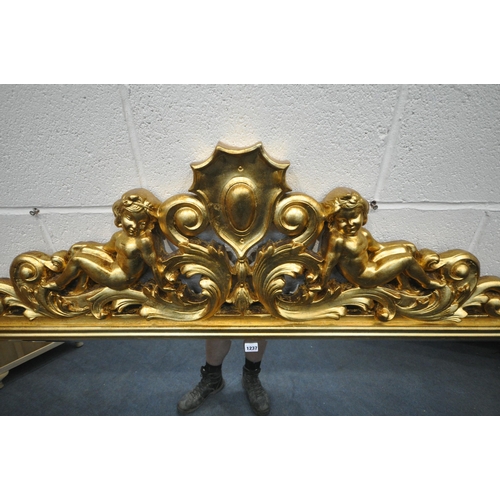 1237 - A LARGE FLAMBOYANT REPRODUCTION GILT WOOD BEVELED EDGE OVERMANTEL MIRROR, the crest depicting two se... 