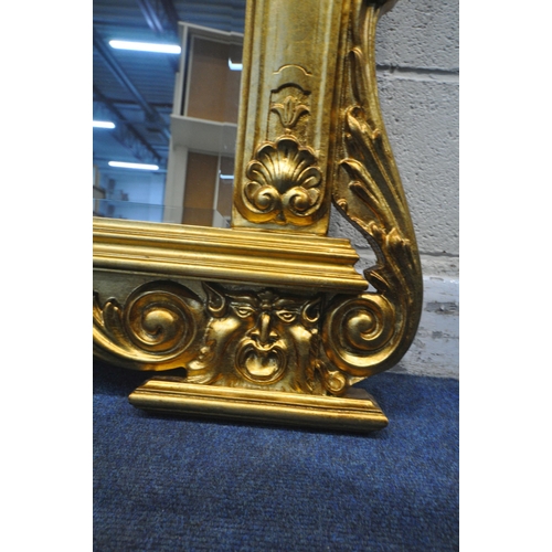 1237 - A LARGE FLAMBOYANT REPRODUCTION GILT WOOD BEVELED EDGE OVERMANTEL MIRROR, the crest depicting two se... 