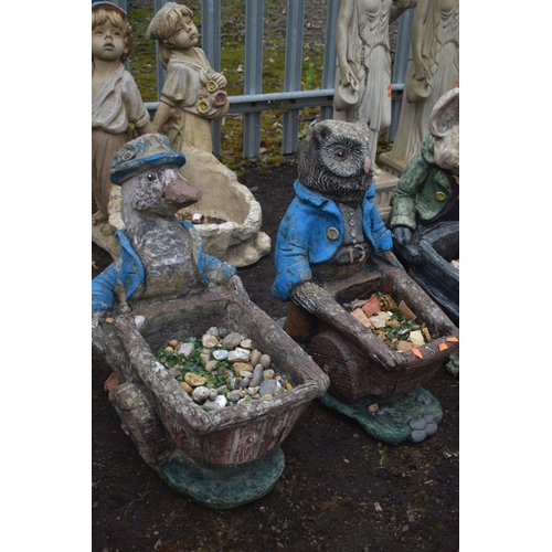 1006 - A SET OF THREE NOVELTY GARDEN FIGURES / PLANTERS, of a duck, owl and a pig carrying a wheelbarrow (c... 