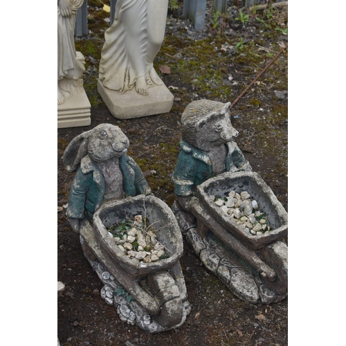 1007 - A SET OF THREE NOVELTY GARDEN FIGURES / PLANTERS, of a fox, rabbit and a badger carrying a wheelbarr... 