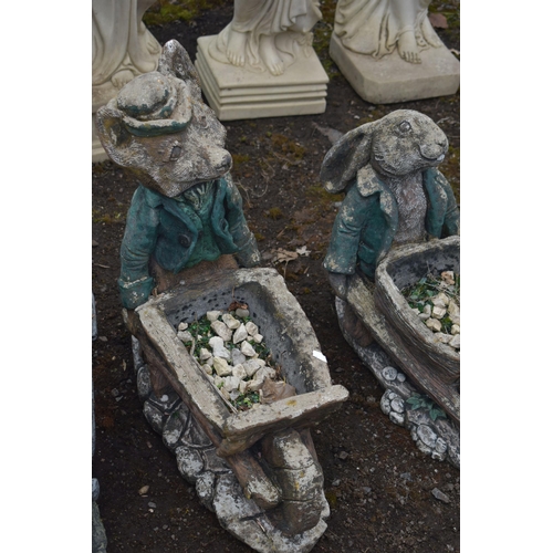 1007 - A SET OF THREE NOVELTY GARDEN FIGURES / PLANTERS, of a fox, rabbit and a badger carrying a wheelbarr... 