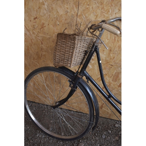 1010 - A VINTAGE BLACK LADIES DUNELT BIKE, with a curved 22 ''  frame, leather saddle and wicker basket (co... 