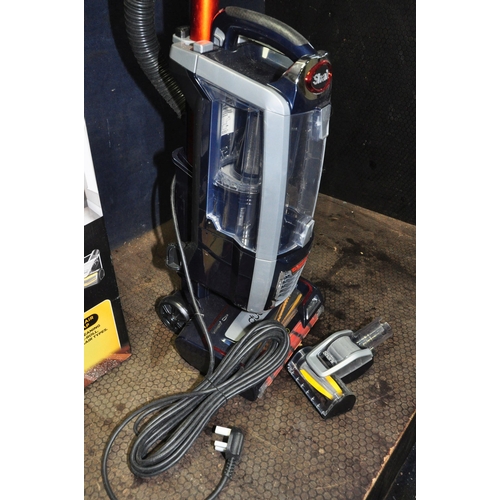 1053 - A BOXED SHARK CORDED UPRIGHT VACUUM CLEANER in original packaging and appears unused (PAT pass and w... 