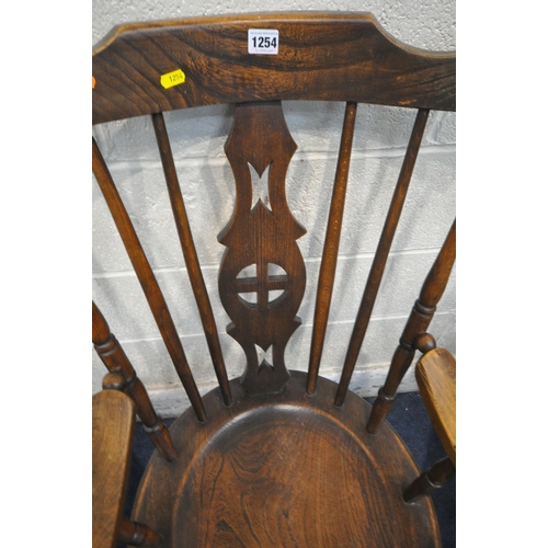 1254 - A 20TH CENTURY ELM ARMCHAIR, with central splat, dish seat, raised on turned legs, united by stretch... 