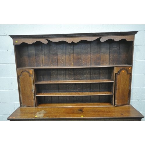 1261 - A GEORGIAN OAK DRESSER, the three tier plate rack with two cupboard doors, atop a base with three dr... 