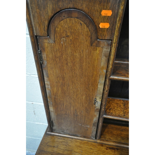 1261 - A GEORGIAN OAK DRESSER, the three tier plate rack with two cupboard doors, atop a base with three dr... 