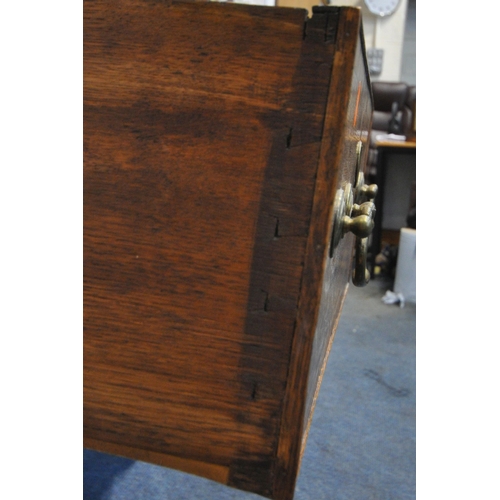 1261 - A GEORGIAN OAK DRESSER, the three tier plate rack with two cupboard doors, atop a base with three dr... 