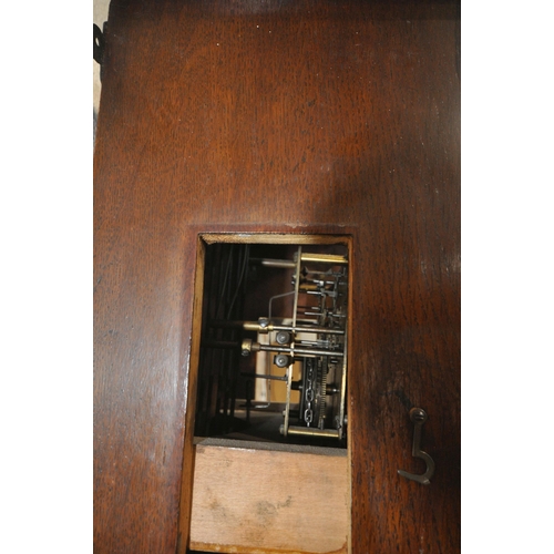 1262 - A 20TH CENTURY OAK LONGCASE CLOCK, the trunk door enclosing a brass 10.5 inch dial, depicting Arabic... 