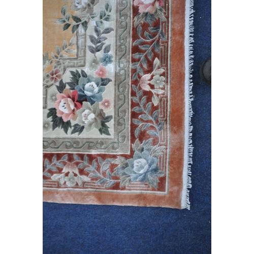 1275 - A RECTANGULAR CHINESE WOOLEN RUG, with various colours, a floral central medallion, surrounded by a ... 