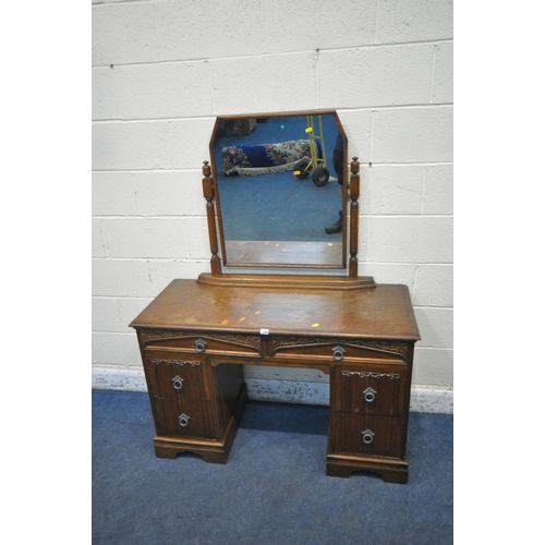 1280 - AN EARLY 20TH CENTURY OAK DRESSING TABLE, fitted with a single mirror, and six assorted drawers, wid... 