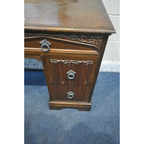 1280 - AN EARLY 20TH CENTURY OAK DRESSING TABLE, fitted with a single mirror, and six assorted drawers, wid... 