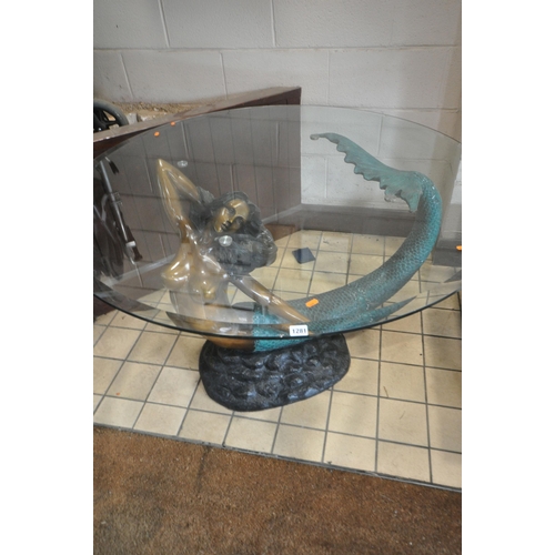 1281 - A TABLE IN THE FORM OF A MERMAID ON SOME ROCKS, with a circular bevelled glass top, diameter 120cm x... 