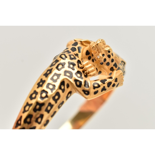 18 - A 'CARRERA Y CARRERA' BRACELET, a Spanish, yellow metal hinged bangle, depicting two leopards, round... 